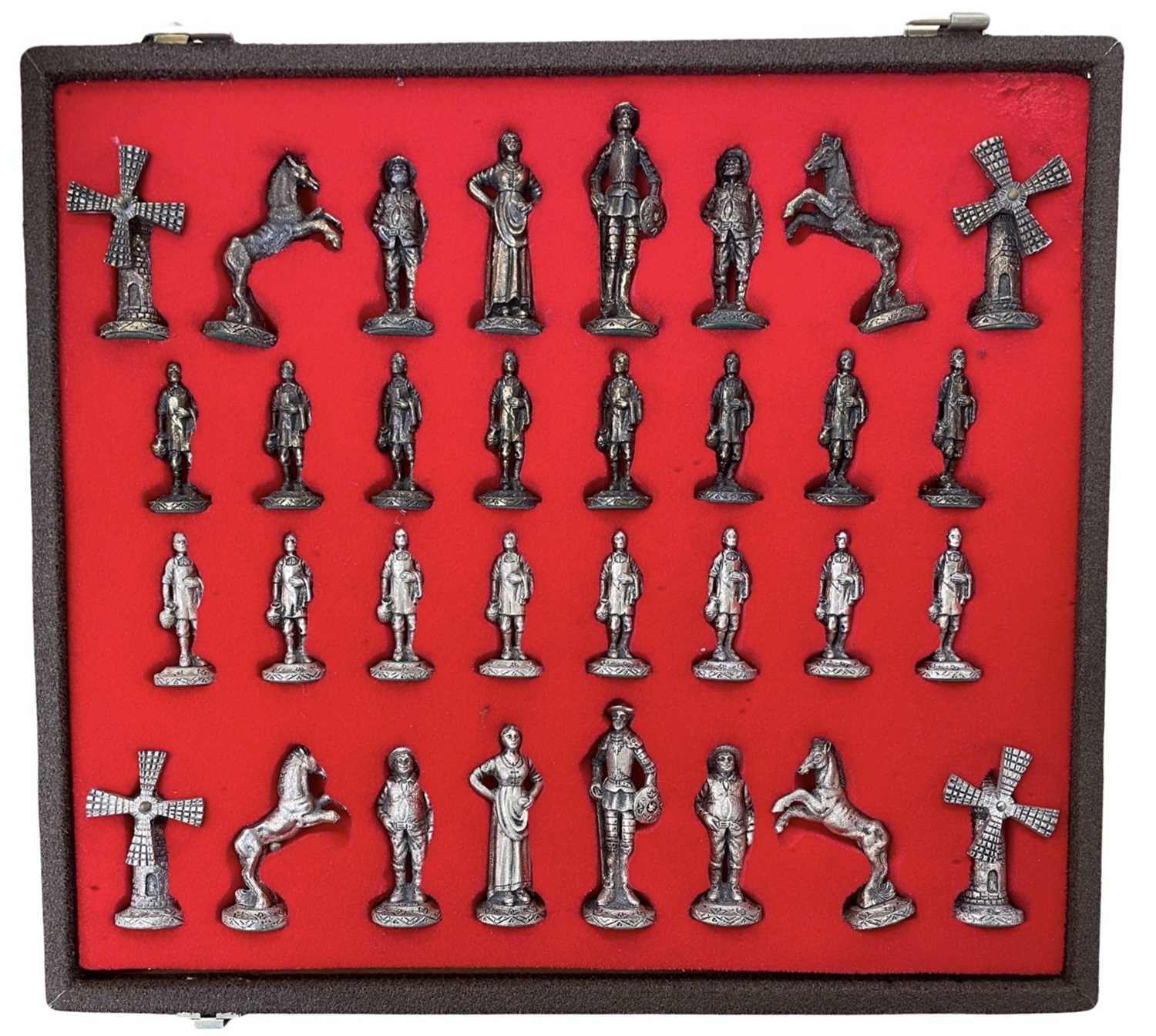 A metal chess set, formed as characters from Don Quixote. Rooks are windmills with rotating blades.