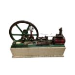 A large single cylinder horizontal stationary steam engine, mounted to composite base, together with
