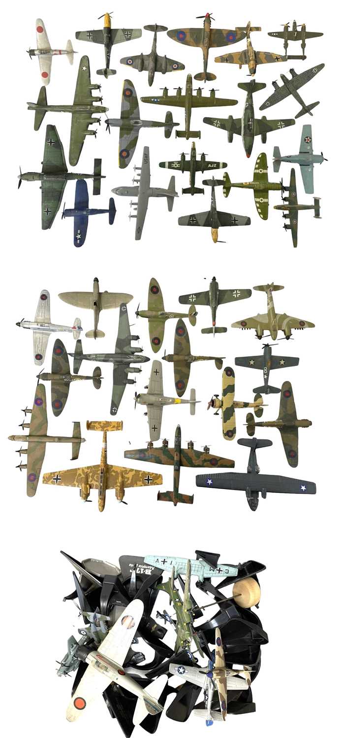 A large collection of various die-cast aeroplanes, together with a quantity of stands