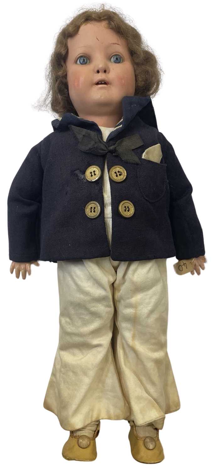 A bisque head Heubach Koppelsdorf doll, dressed in sailor's outfit. Marked to rear of head: