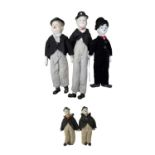 A group of porcelain head dolls, modelled after Charlie Chaplin and Laurel and Hardy. Lengths
