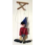 A scratchbuilt hand painted wooden marionette puppet formed as Enid Blyton's Noddy