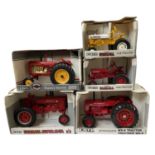 Five boxed ERTL die-cast tractor models, to include: - Cub - Farmall - McCormick WD-9 - Farmall