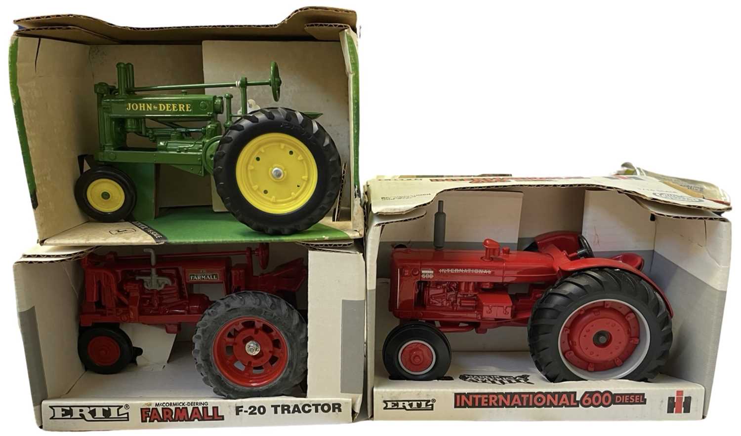 Three boxed ERTL die-cast tractors, to include: - International 600 Diesel - Farmall F-20 - 1934