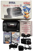 A boxed Sega Master System II, with Slap Shot and Star Wars games