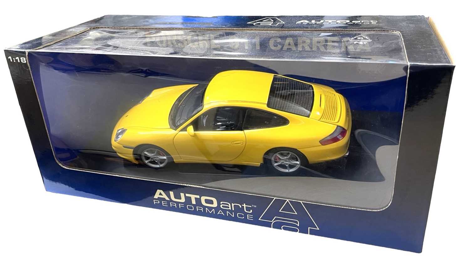 A boxed AutoArt 1:18 scale Porsche 911 Carrera in bright yellow