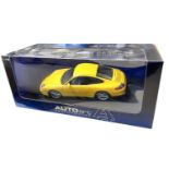 A boxed AutoArt 1:18 scale Porsche 911 Carrera in bright yellow