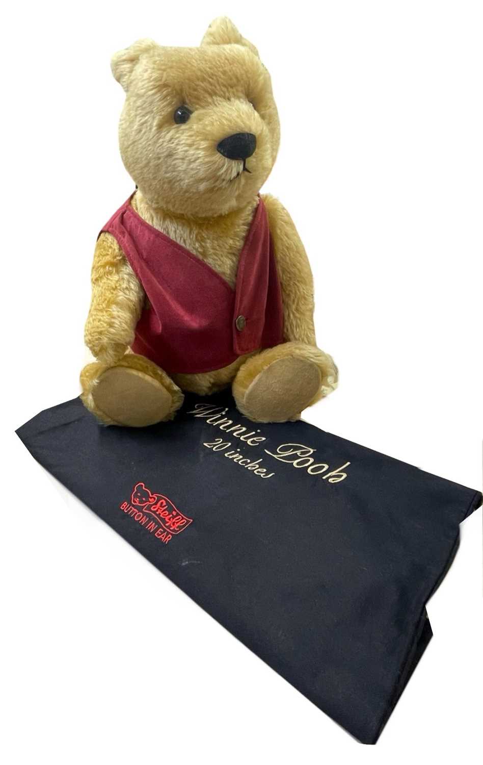 A large Steiff Winnie the Pooh bear in red waistcoat with internal growler. Limited number 02249/