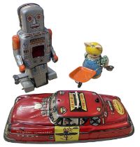 Three vintage tinplate toys, to include: - Dibro Fire Chief car - Yoneya Robot - Cat with
