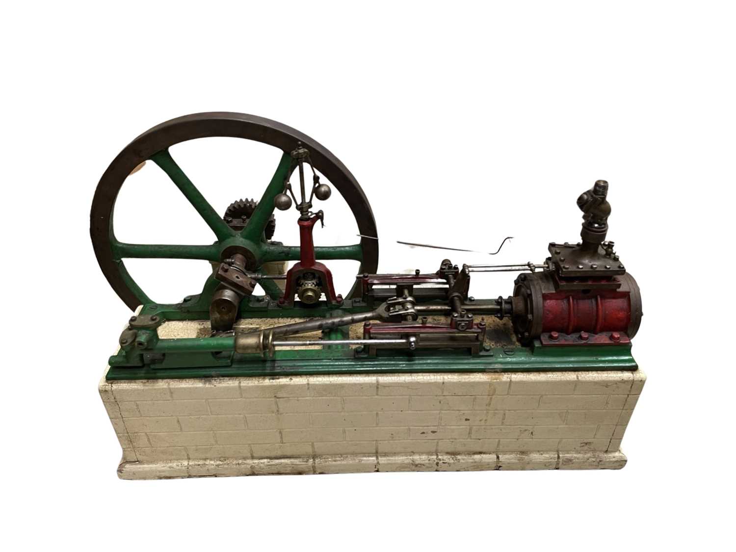 A large single cylinder horizontal stationary steam engine, mounted to composite base, together with