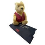 A large Steiff Winnie the Pooh bear in red waistcoat with internal growler. Limited number 02249/