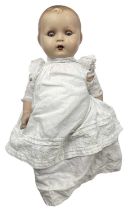 An Armand Marseille bisque head doll, with blue weighted eyes and open mouth with visible teeth