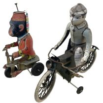 A pair of vintage Chinese tinplate toys, formed as a performing monkey and a gent on a bicycle (a/
