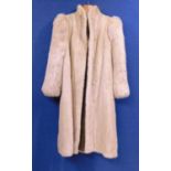 A lady's full length cream fur coat by Hurtiq Ltd overall good with no obvious signs of wear or