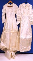 Two mid 20th Century cream satin wedding dresses, (2)