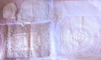 A mixed lot of lace to include a baby's bonnet, lace edged handkerchief, table mats, etc