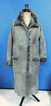 A lady's three quarter length sheepskin coat by Higgs, single breasted with three button front,