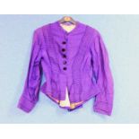 A late 19th century lady's purple jacket, with covered black velvet buttons, peplum waist and