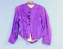 A late 19th century lady's purple jacket, with covered black velvet buttons, peplum waist and