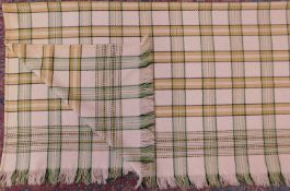 A Welsh blanket, in cream, green, yellow, black and red check, fringed edging on two sides,