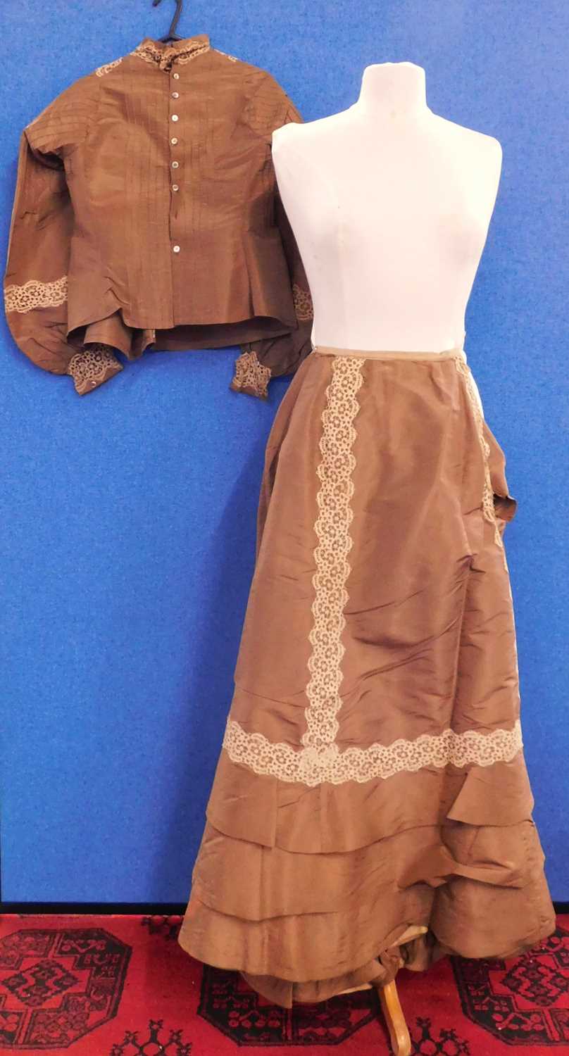 A Victorian lady's brown silk blouse and matching skirt, the blouse with pin detailing to front