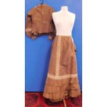 A Victorian lady's brown silk blouse and matching skirt, the blouse with pin detailing to front