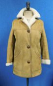 A lady's sheepskin jacket by Nurseys, single breasted, three button fastening, front pockets, turn-