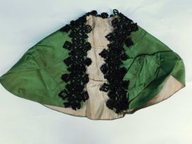 A late 19th/early 20th century children's cape, the olive green silk arc with tailored shoulders