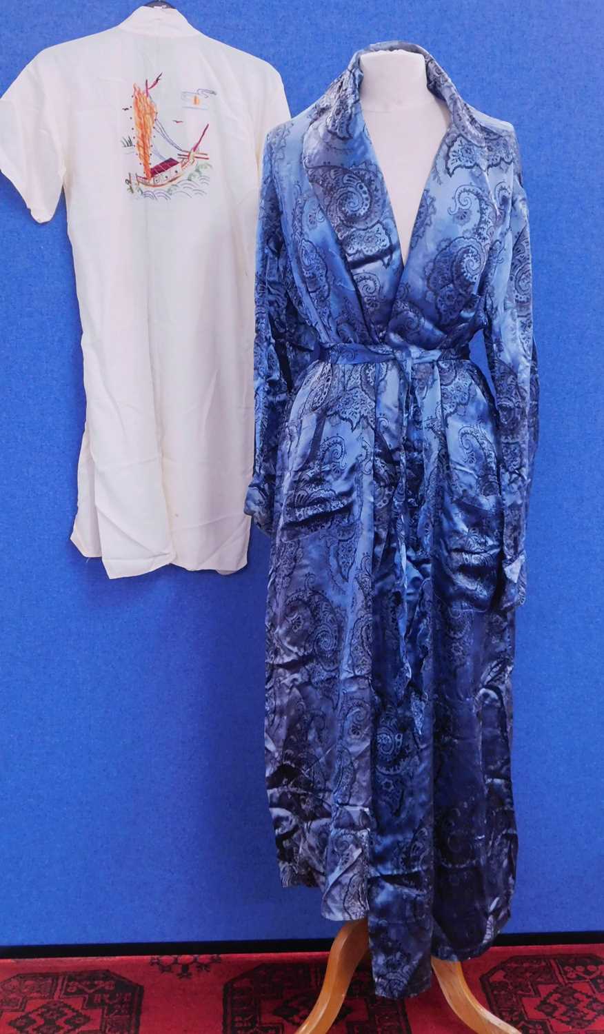 An early/mid 20th century blue paisley kimono style robe together with a childs white cotton