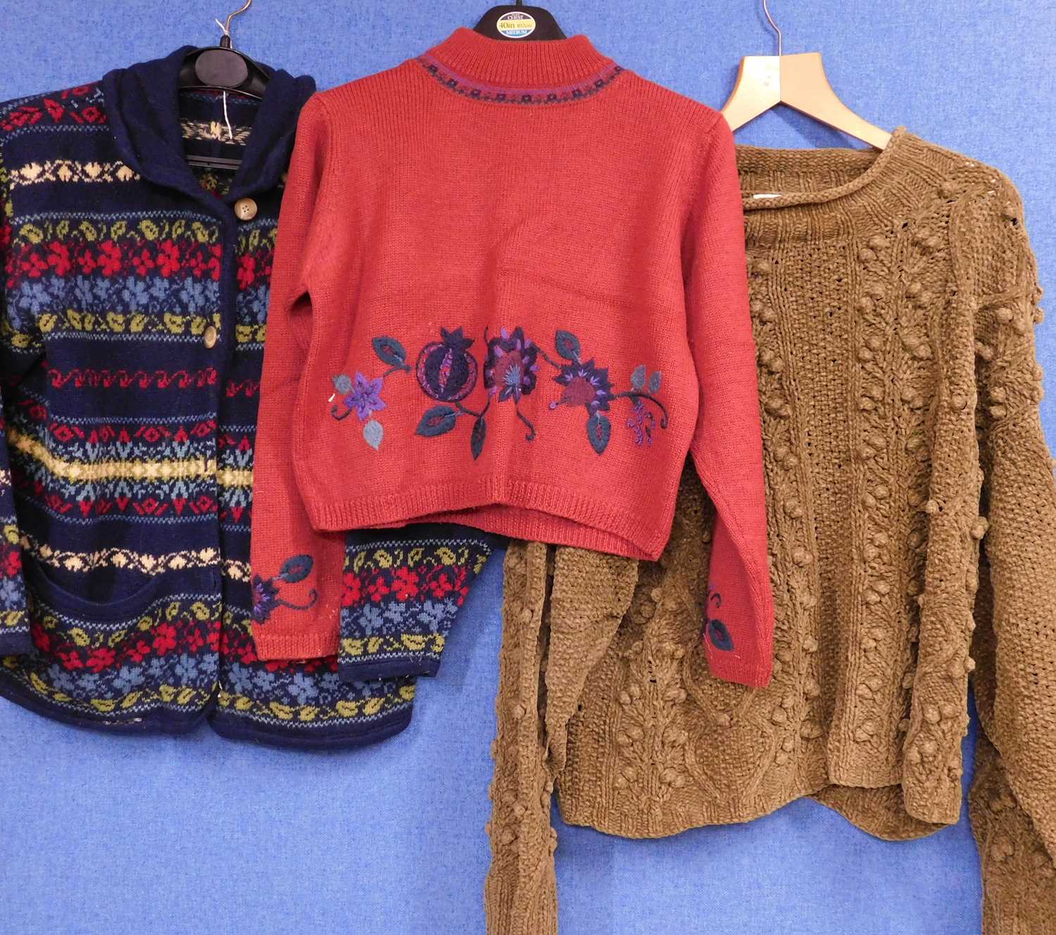 Three items of ladies knitwear to include a blue patterned cardigan by Laura Ashley, a cropped red