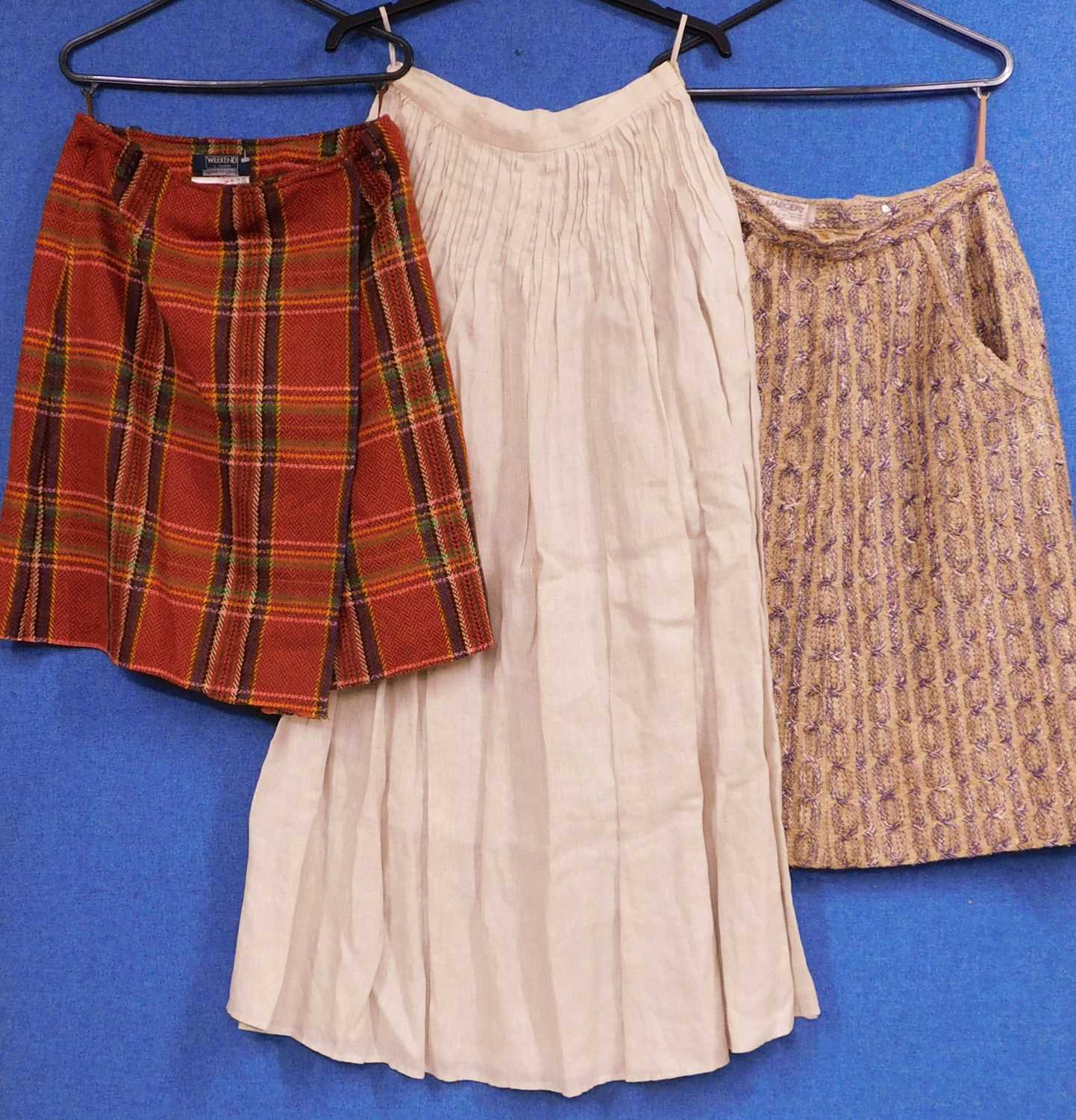 Three lady's skirts to include a cotton wool blend skirt by Jaeger, size 10, a beige linen skirt