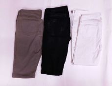 Three pairs of jeans by Helmut Lang, to include a pair of taupe jeans, size 27, a pair of black