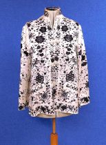 A white satin and black embroidered Chinese jacket by Plum Blossom, with high collar, long sleeves