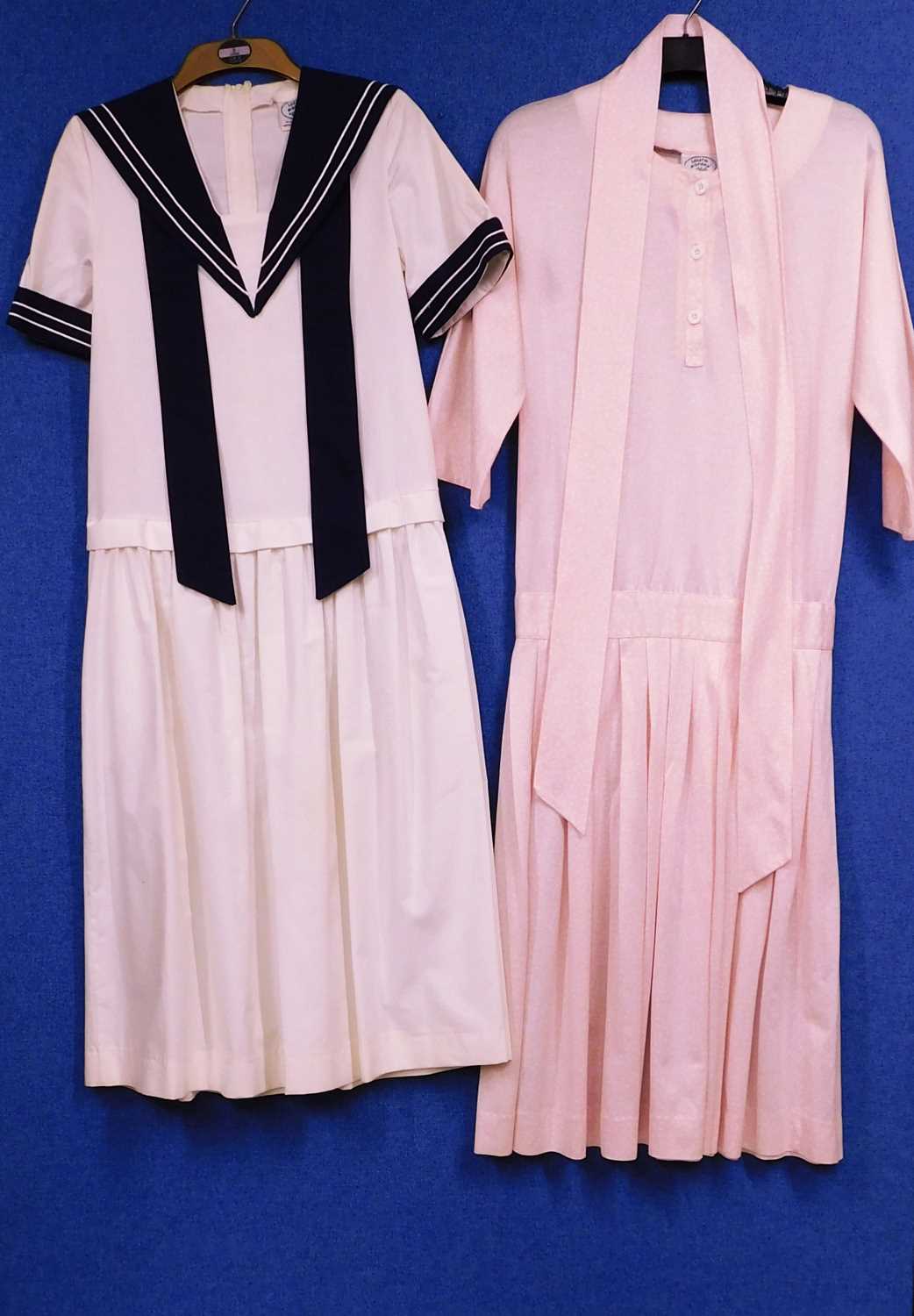 Two Laura Ashley dresses to include a cream and navy blue sailor dress and a pink and white