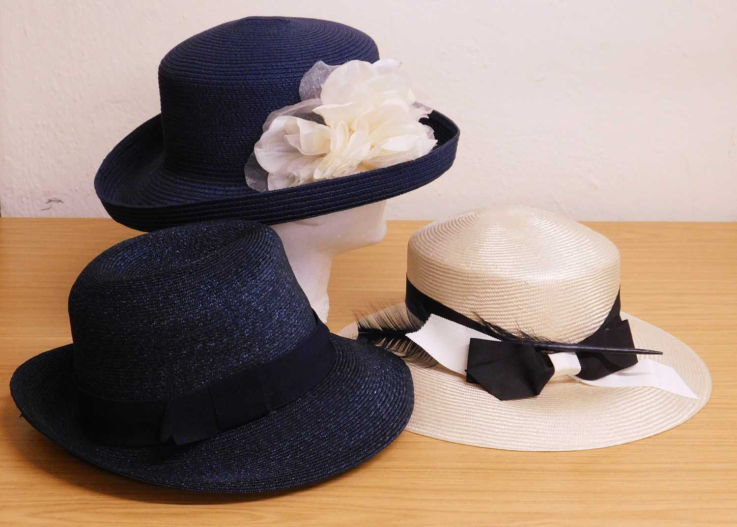 Three occasion wear hats to include a navy blue straw trilby by Lock & Co, a straw and floral