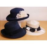 Three occasion wear hats to include a navy blue straw trilby by Lock & Co, a straw and floral