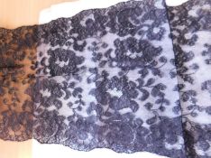 A late Victorian black lace shawl, approx. 39cm wide x 200cm long