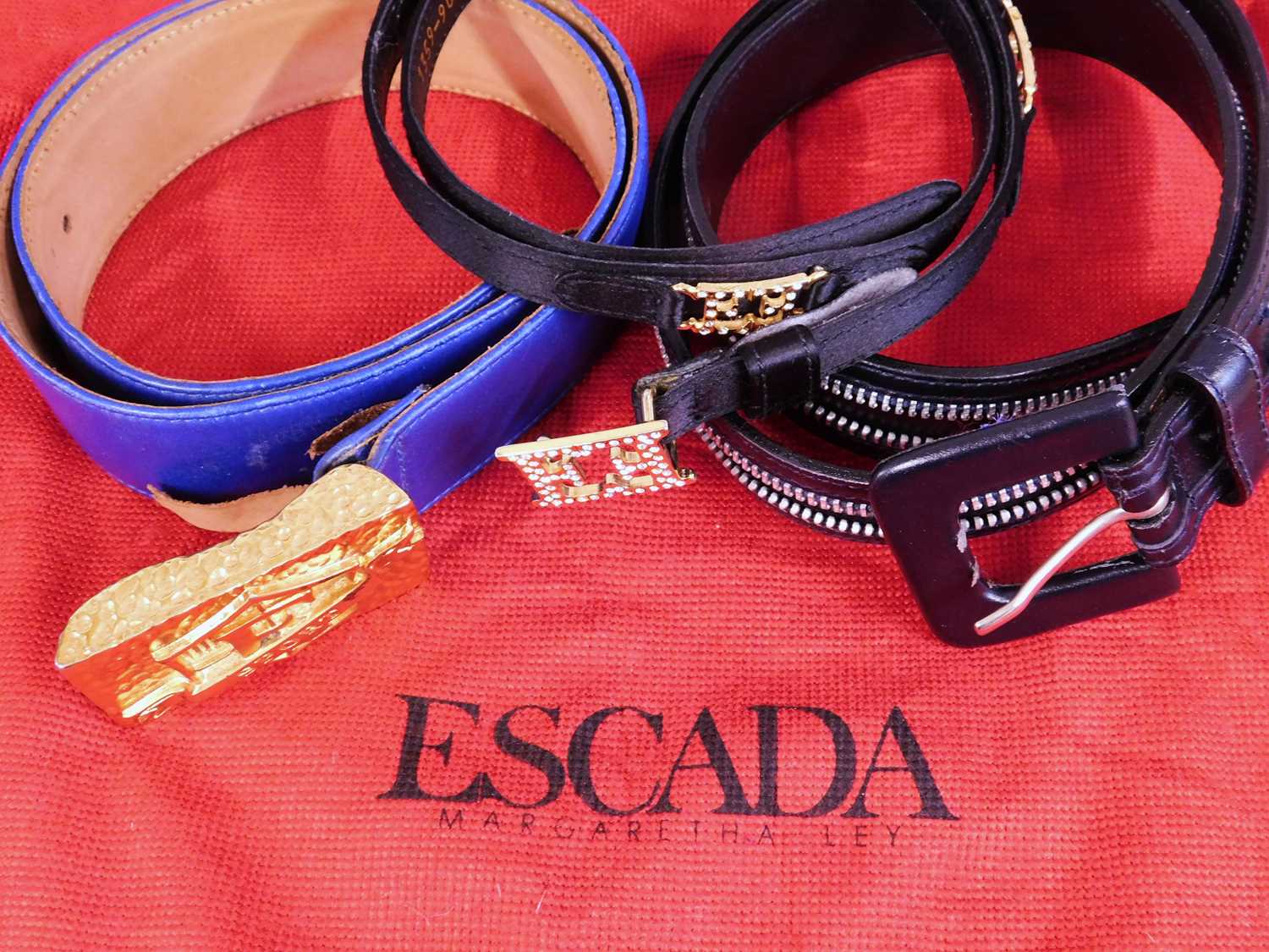 Three Escada leather belts: one in blue with gilt metal buckle, 3.8cm wide x 90cm long, one black