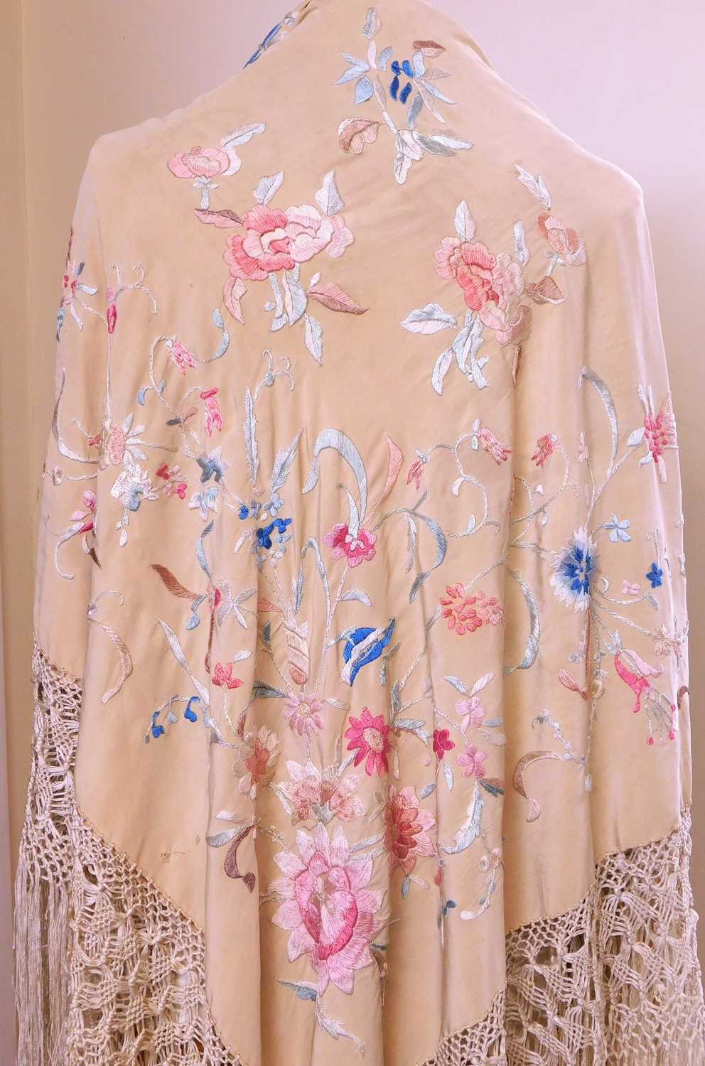 A late 19th / early 20th century silk floral embroidered fringed shawl, together with another