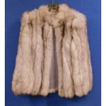 A lady's long haired cream fur jacket very supplesome loose hairsgood clean condition