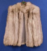 A lady's long haired cream fur jacket very supplesome loose hairsgood clean condition