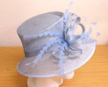 A Dusk straw hat in pale blue, 'Frieda' design bow and feather detail, new with tags