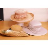 Three occasion wear hats to include a straw, lace and beaded hat by Simon Ellis, a beige satin hat