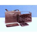 A small group of mid 20th Century lady's accessories to include two mock croc brown leather