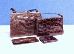 A small group of mid 20th Century lady's accessories to include two mock croc brown leather