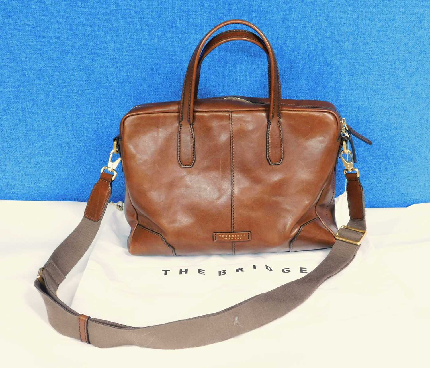 A tan leather tote bag by The Bridge, with top zip fastening with hand straps and detachable