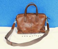 A tan leather tote bag by The Bridge, with top zip fastening with hand straps and detachable