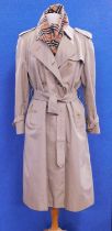 A lady's Burberry double breasted trenchcoat, size 16 Petite, together with a Burberry cashmere
