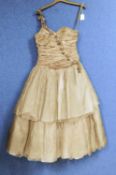 A lady's one shoulder gilt taffeta dress by Frou-Frou, Sandra Ruffell, with two tiered skirt with