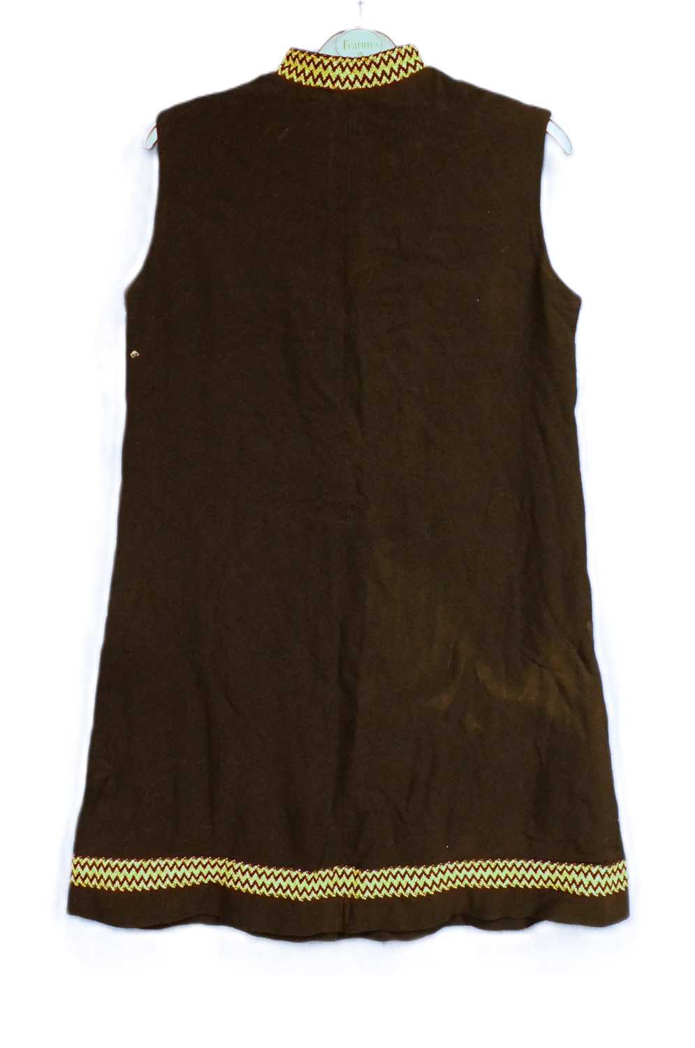 A ladies mid 20th Century sleeveless shift mini dress with black and gold detailing to neck and hem,